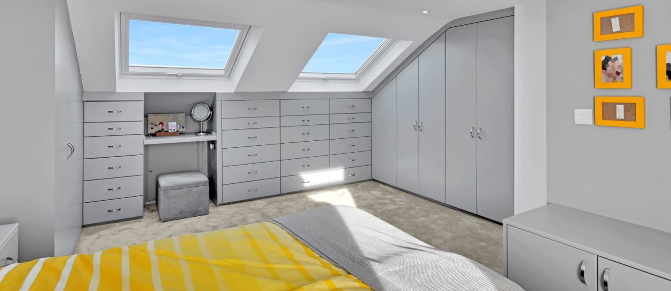 Loft conversion bedroom with bespoke fitted wardrobes, drawers and Velux roof windows, featured on the Billericay CM12 Our Work page