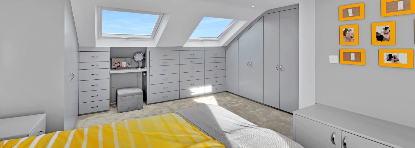 Loft conversion bedroom with bespoke fitted wardrobes, drawers and Velux roof windows, featured on the Billericay CM12 Our Work page