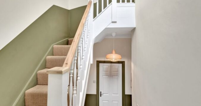 Spacious loft living room with rooflights, grey carpet and a seating area in a Winchmore Hill N21 loft conversion